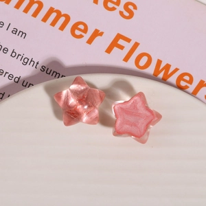 Close-up of translucent pink star resin charms for DIY jewelry and phone case crafts