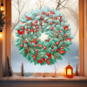 Blue-green Christmas pine wreath with red ornaments hanging on a snowy window