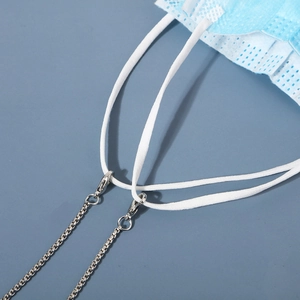 Detail of silver box chain link and lobster clasp attached to a blue face mask strap