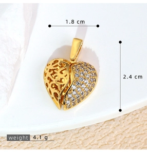 Macro detail of heart wing pendant showing 1.8cm width and 2.4cm height dimensions