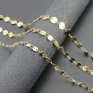 Macro shot of 18K gold plated stainless steel disc chain with polished circular links