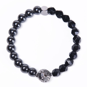 Detailed view of beaded bracelet with black faceted tiger eye stones and silver lava bead