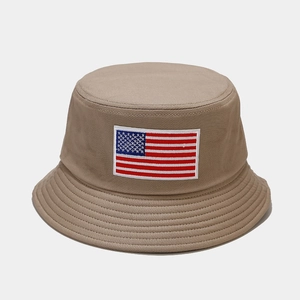 Close-up of the USA flag embroidery and stitching on a khaki cotton bucket sun hat