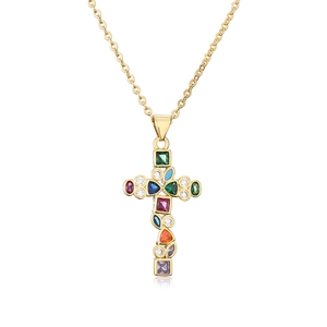 Golden cross necklace with colorful zircon gemstones on a white background