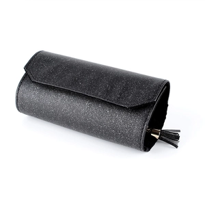 Portable black jewelry roll organizer with glitter texture and gold tassel hardware
