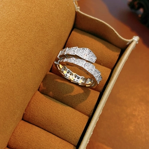 Detailed macro view of silver snake scale ring with pavé-set cubic zirconia in velvet box