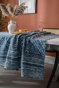 Detail of blue geometric triangle printed cotton linen tablecloth with smooth drape