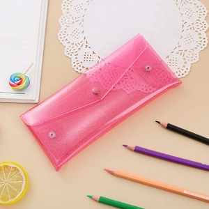 Macro detail of pink glitter PVC stationery pouch with a functional snap button closure