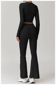 Rear view of black skin-friendly yoga set with cropped top and flare pants for fitness
