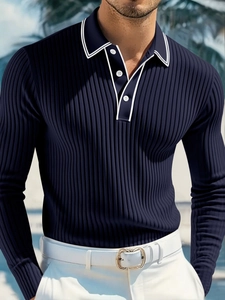Detail of navy knit long sleeve Polo shirt with contrast white collar and button neckline