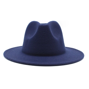 Detailed close-up showing the classic pinched crown of a navy blue wool felt fedora hat