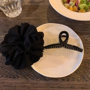 Detail of elegant black lace embroidery scrunchie and premium acrylic hair claw clip set