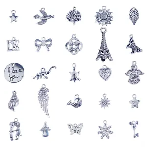 Macro view of 25-piece vintage silver alloy charms featuring Eiffel Tower and tree designs