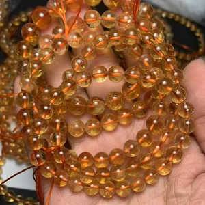 Natural Brazilian Citrine Crystal Bracelet with translucent orange beads on wrist