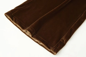 Detailed close-up of dark coffee velvet fabric texture and professional hem stitching