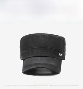 Close-up of vintage dark grey denim cadet cap with washed texture and stitched side label