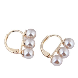 Elegant gold C-shaped hoop earrings featuring three vertical white pearls on white background