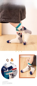 Detail of mesh baby socks with blue cartoon elephant and red star patterns in soft cotton