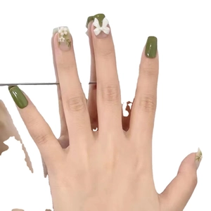 Glossy green press-on nails with 3D white bow and delicate floral nail art designs
