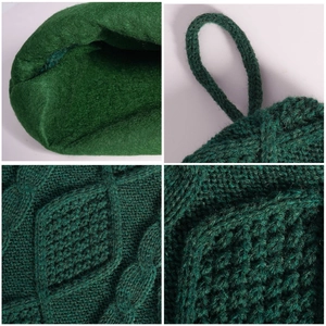 Dark green knitted bone-shaped Christmas stocking with cable knit and diamond patterns