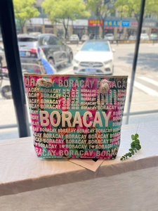 Detail of tropical floral print canvas bag with thick rope handles and Boracay text