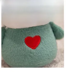Close-up of green plush toy featuring high-quality faux fur and a red heart embroidery