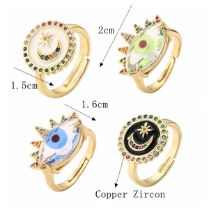 Detailed view of adjustable gold rings with moon, star, and evil eye zircon charms