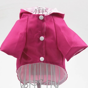 Detail of rose red pet raincoat with breathable mesh lining and secure snap buttons