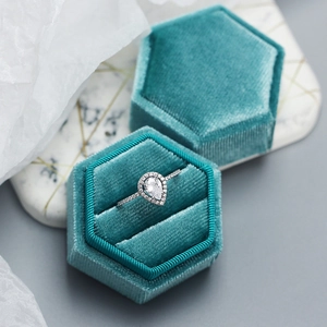 Elegant s925 silver pear-cut cubic zirconia ring inside a blue hexagonal velvet jewelry box