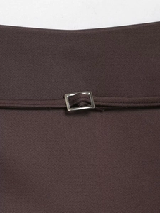 Detailed close-up of dark brown woven fabric with a silver rectangular metal buckle