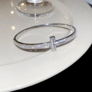 Macro de zircons pavés et design en T sur le bracelet jonc ouvert en argent poli