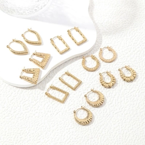 Minimalist gold stainless steel earring set with various geometric shapes on white surface