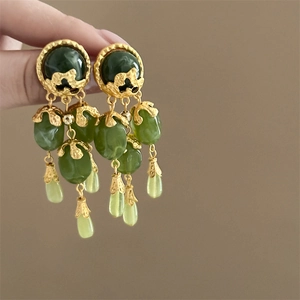 Vintage gold earrings with green fringe beads and floral tassels in a retro palace style