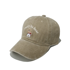 Detailed embroidery of Lucky So Bear on khaki washed cotton baseball cap texture