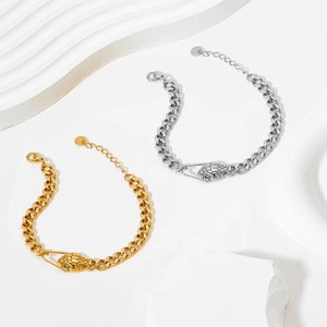 Minimalist snake head cuban chain bracelet in gold and silver finish with green stone eyes