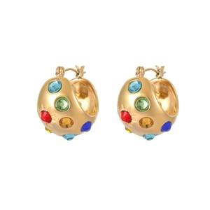Detailed view of luxury gold earrings with colorful zircon stones in a wide band design