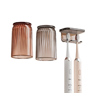 Magnetic wall-mounted toothbrush holder with two striped cups and dental storage rack