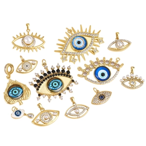 Selection of gold evil eye pendants with sparkling crystals and colorful enamel charms