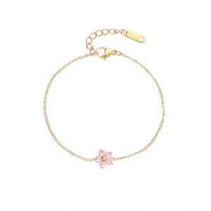 Elegant gold stainless steel flower bracelet with a pink petal charm on white background