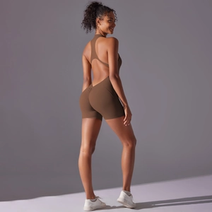 Detail of cross-back straps and cutout design on brown athletic bodysuit for yoga