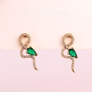 Elegant gold snake earrings with white crystals and pear-shaped green stones