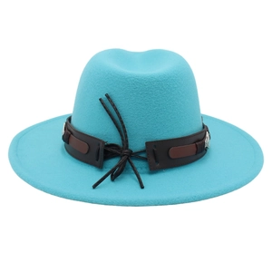 Detail of wide brim teal felt fedora featuring leather band and carved metal ornament