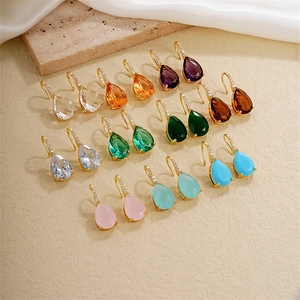 Detail of teardrop zircon earrings in various colors with micro-pave gold hooks