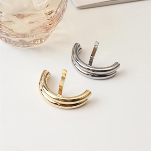 Detail of minimalist metallic hair pin in gold and silver finish with insertion pin