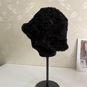 Close-up of black teddy fleece fisherman hat showing textured warm faux fur fabric