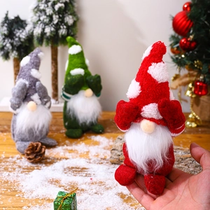 Three Christmas gnomes in red, green, and grey plush fabric with festive knitted hats
