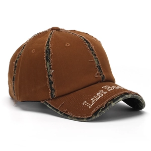 Close-up of vintage brown cotton baseball cap with 3D letter embroidery and camo details