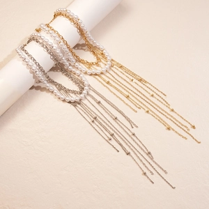 Double-layered pearl tassel necklace set with layered gold and silver chains for women