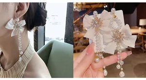 Detail of s925 silver long silk bow earrings with tassel pearls and rhinestone sun flower
