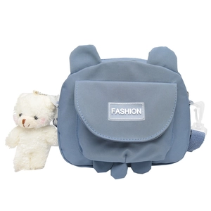 Blue canvas crossbody bag with white plush bear charm and fashion label in Japanese style